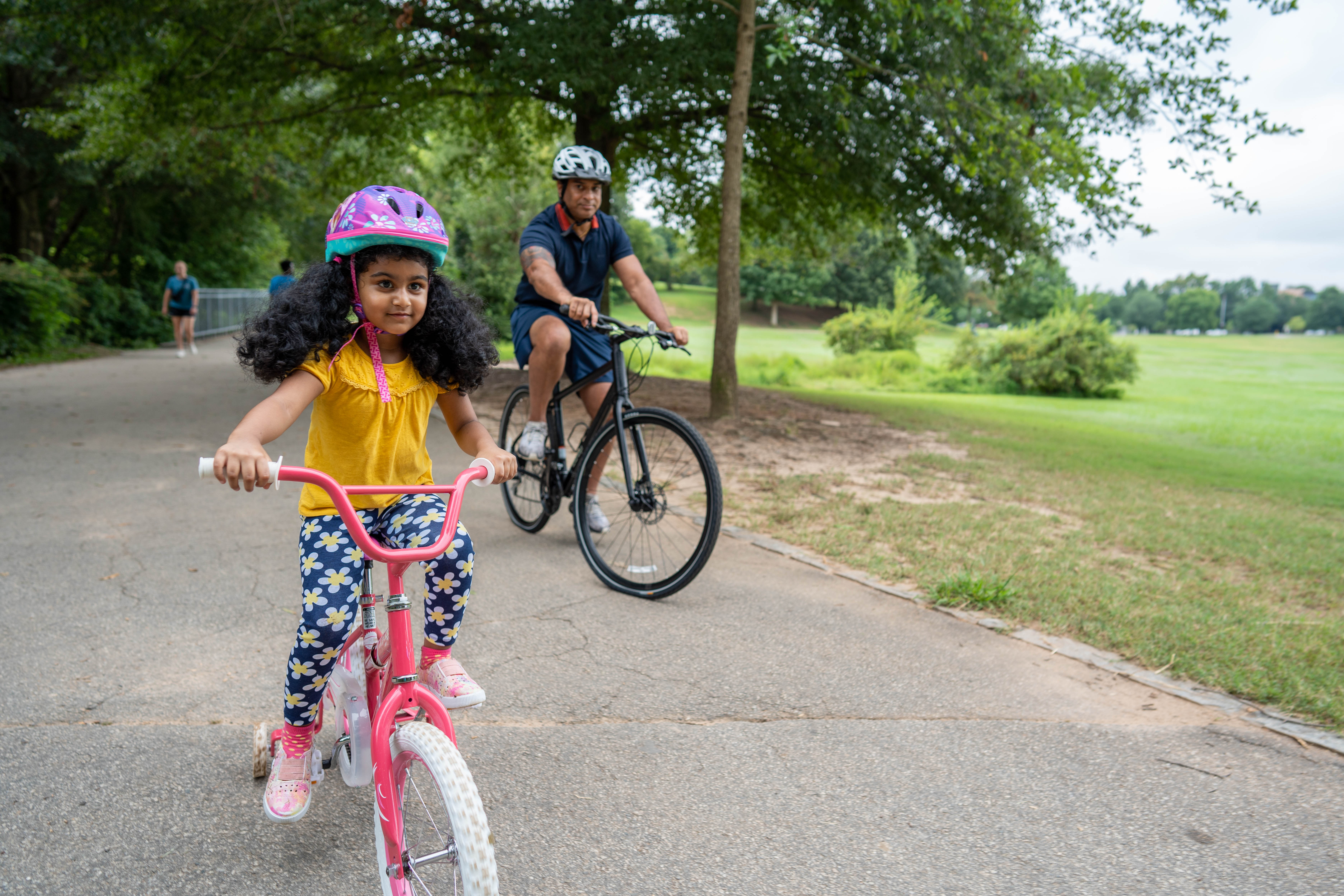 More Details about Child Riding Bike Along Parent - 1