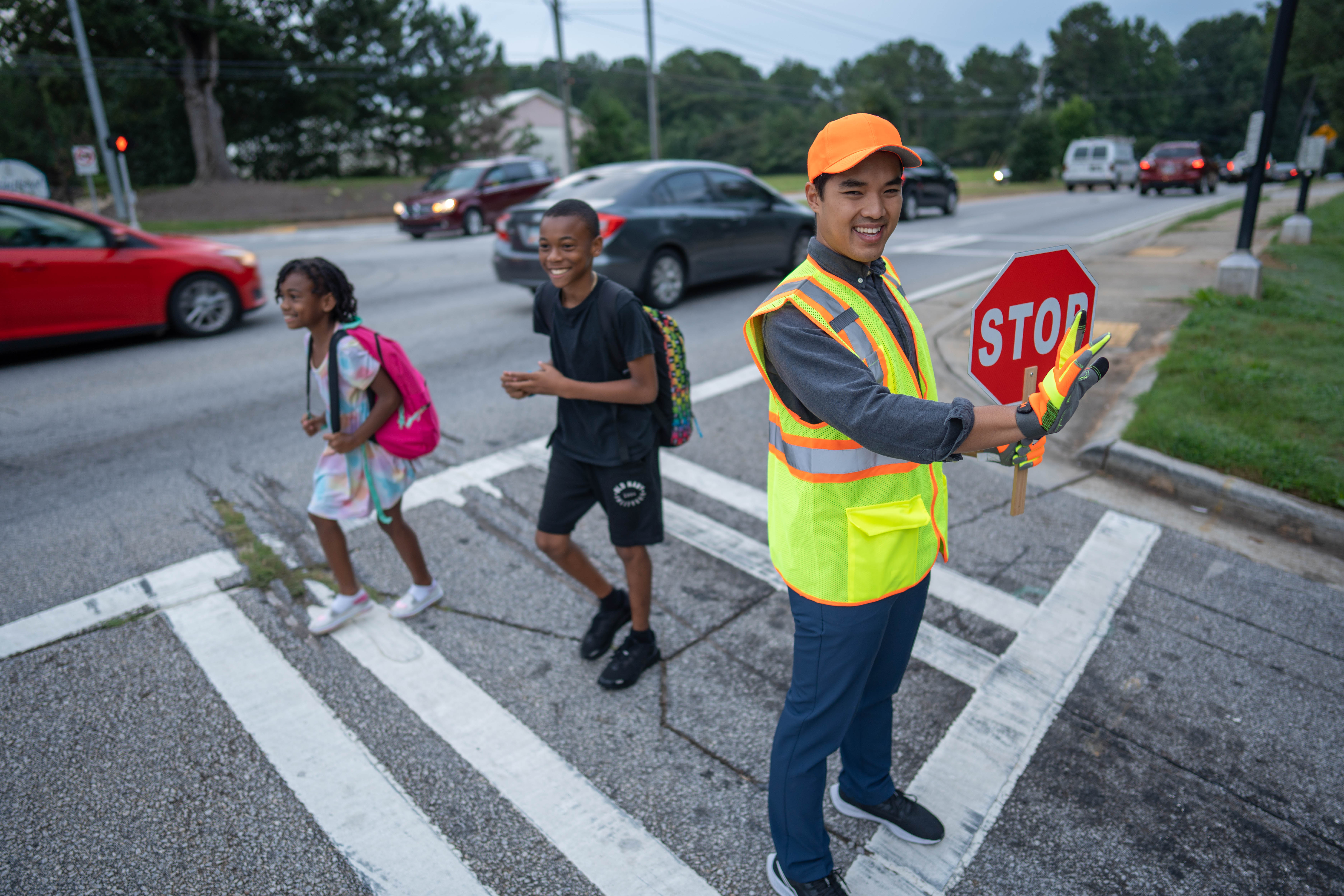 More Details about Crossing Guard Holding Stop Sign